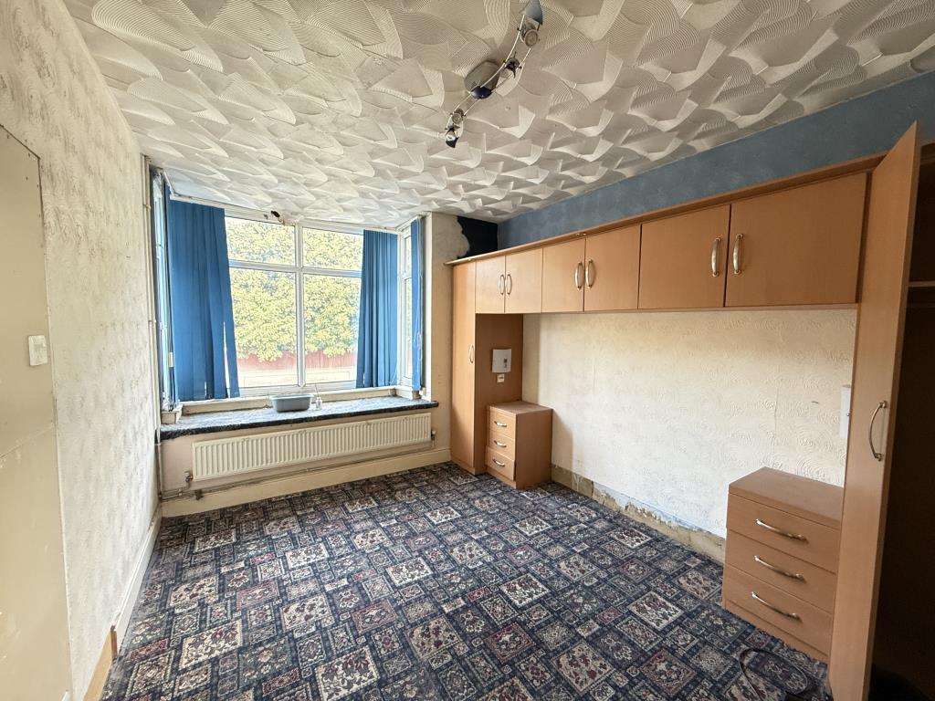 Lot: 107 - TWO-BEDROOM FLAT WITH GARAGE IN NEED OF IMPROVEMENT - Bedroom one with bay window